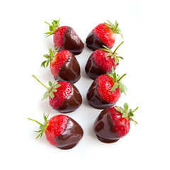 Row of strawberries dipped in delicious chocolate isolated on white