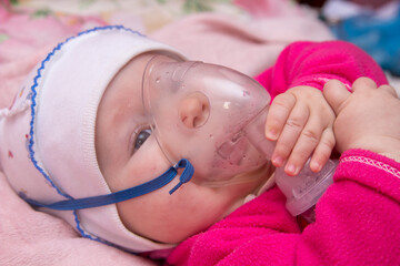 treatment of baby from influenza,the baby breathes through an oxygen mask by inhaling medication to...