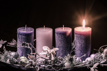 one burning candle on advent wreath