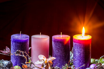 one burning candle on advent wreath