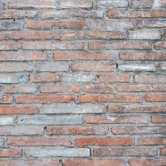 old brick wall of bricks of different sizes as background