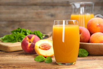 Natural peach juice and fresh fruits on wooden table