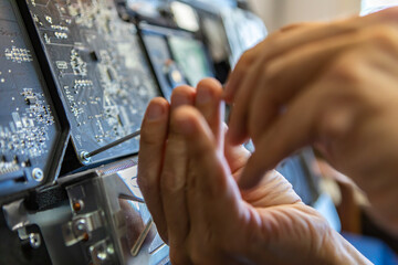 Obraz premium Selective focus of male technician hands unscrewing bolts to analyse issue with broken computer and resolve it for smooth functioning