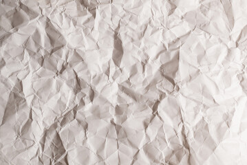 Crumpled white paper background.