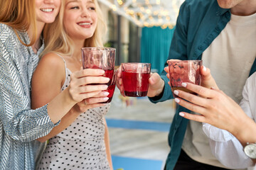 group of happy friends celebrating in cafe, they clink glasses with sweet beverages, leisure, celebration, drinks, people and holidays concept