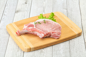 Raw pork bone steak over wooden