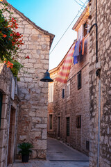 Narrow old street in Jelsa town, Hvar island, Croatia.