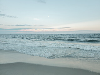 City Beach, Rockaway beach, quiet and empty ocean with a peaceful glow in the background. New York