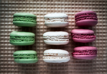 Colored macarons on waffle background