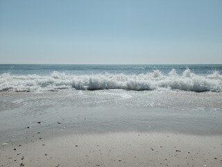 City Beach, Rockaway beach, quiet and empty ocean with a peaceful glow in the background. New York