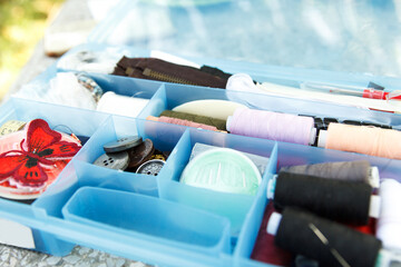 Sewing box with threads, needles and buttons