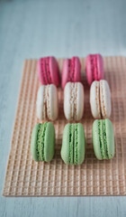 Colored macarons on waffle background
