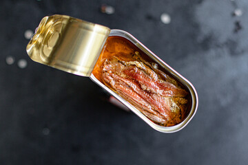 anchovies canned fish in a tin can seafood top view copy space for text food background rustic diet...
