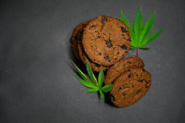 Cannabis leaf. Chocolate cookies. Marijuana food. Medical weed edibles. CBD oil. Copy space