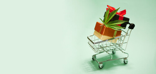 Cannabis leaf with shopping cart. Christmas gifts. New Year sale banner. Marijuana online store....