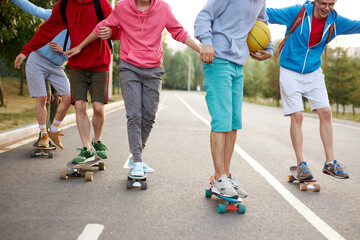urban teen boys on skateboards,young boys riding in the park on a skateboard. city style. urban...