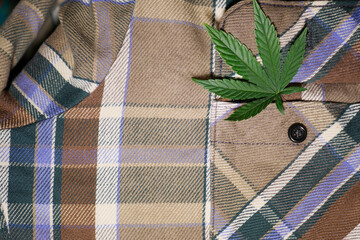 Cannabis leaf on textile texture. Weed cloth material. Alternative fiber. Eco clothing