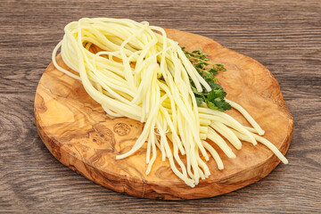 Chechil spaghetti cheese over board