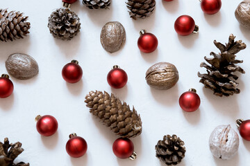 composition of cones, nuts, Christmas red balls on a white background Merry Christmas
