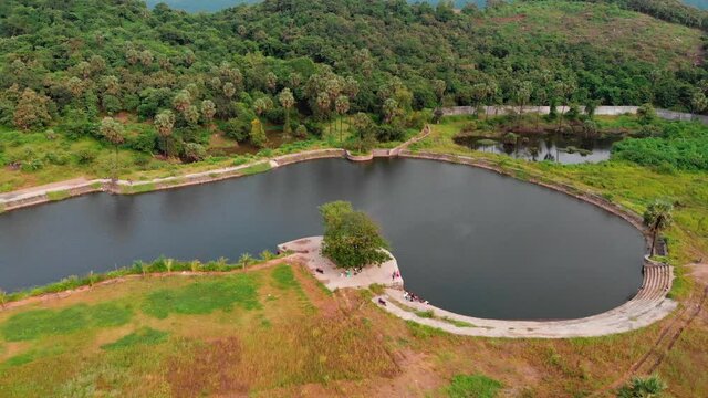 UHD drone shot  birds-eye view  picnic spot  by the lake over the mountain jungle