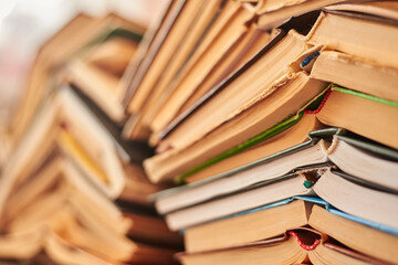 Old books piled up in a heap, learning and education concept.
