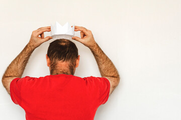 man and a white paper crown. The man is offered a crown. hands hold crown over head. Coronation...