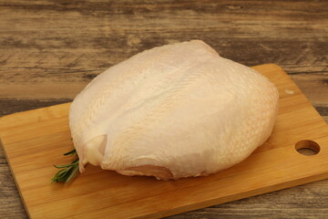 Raw whole chicken breast with skin