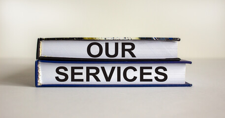Books with text 'our services' on beautiful white background. Business concept. Copy space.