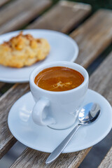 Cup of coffee on table in coffee shop cafe.A cup of coffee and coffee beans with croissant on the table