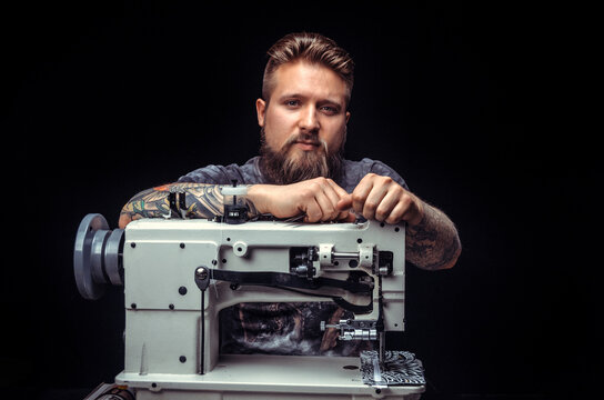 Artist working with leather creates a new leather product at his tanning shop