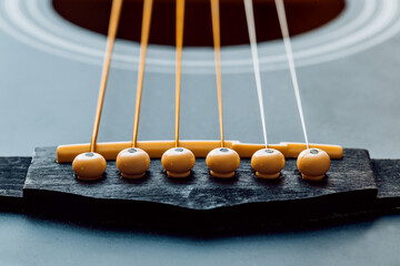 Attaching strings to the body of an acoustic guitar - stand and nut on the soundboard