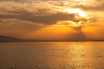 sunset view on the lake. a fishing boat in the lake.