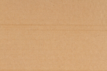 Fototapeta na wymiar Brown textured cardboard paper closeup background
