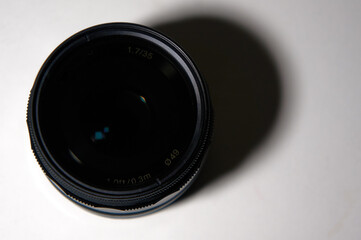 Photo of the lens on a white background with a falling shadow. Photo in jpeg format.