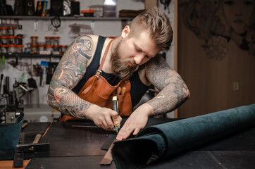 Leather Currier creating new leatherwork in his tanner shop