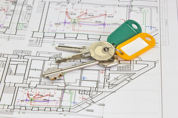 architectural drawings on a white sheet with keys to the house, the concept of construction and design of real estate