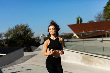 Full length portrait of fitness woman on morning run outdoors