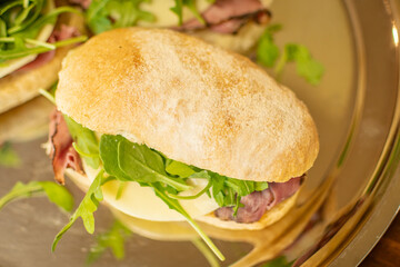 Prosciutto Italian sandwich with arugula and provolone cheese - top view angle
