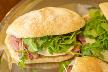 Prosciutto Italian sandwich with arugula and provolone cheese - top view