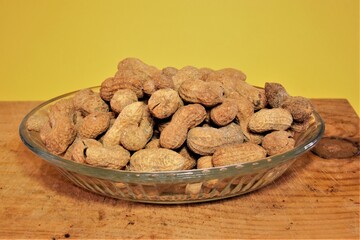Groups of salted and baked peanuts. Unshelled and shelled peanuts and baked with salt. Isolated background.