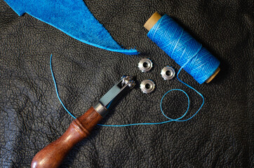 Genuine Leather. Sewing a purse. Leather work. Tools for sewing wallets, clutches. Stitching. Manual sewing of the product. The manufacture of leather products.