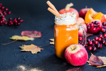 Halloween cocktail, pumpkin orange drink with spices. Dark vintage dirty background. Creative atmospheric decoration