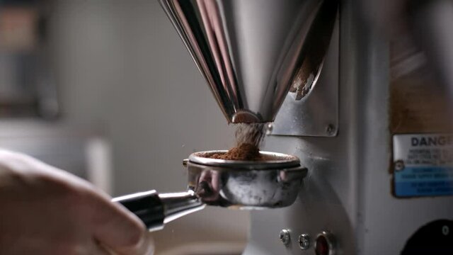 Perfect coffee grind. Coffee shop artisan at work preparing a crafted espresso. Shot in 4k. 
