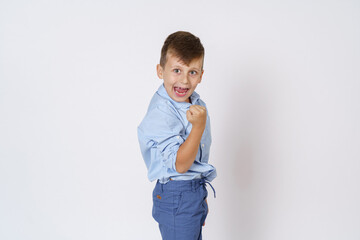 The boy expresses emotions - victory, with a hand gesture. Isolated on white background.
