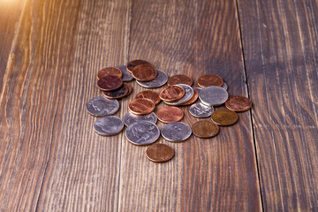 American coins and US dollars on a wooden table