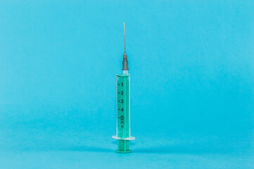 medical syringe on blue background