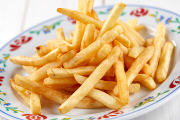 golden french fries on the wooden background