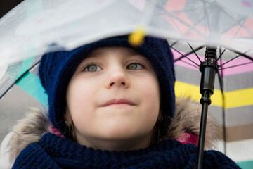 Portrait of a little girl under an umbrella.