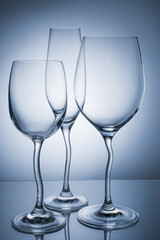 Wine glasses with reflection on a colored background