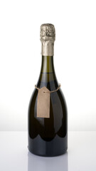 A bottle of alcohol with a tag on a rope on a light background. Concept of Festive alcoholic beverages.